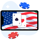 Dispositivo móvil con la bandera de Estados Unidos en su pantalla, junto a 2 naipes